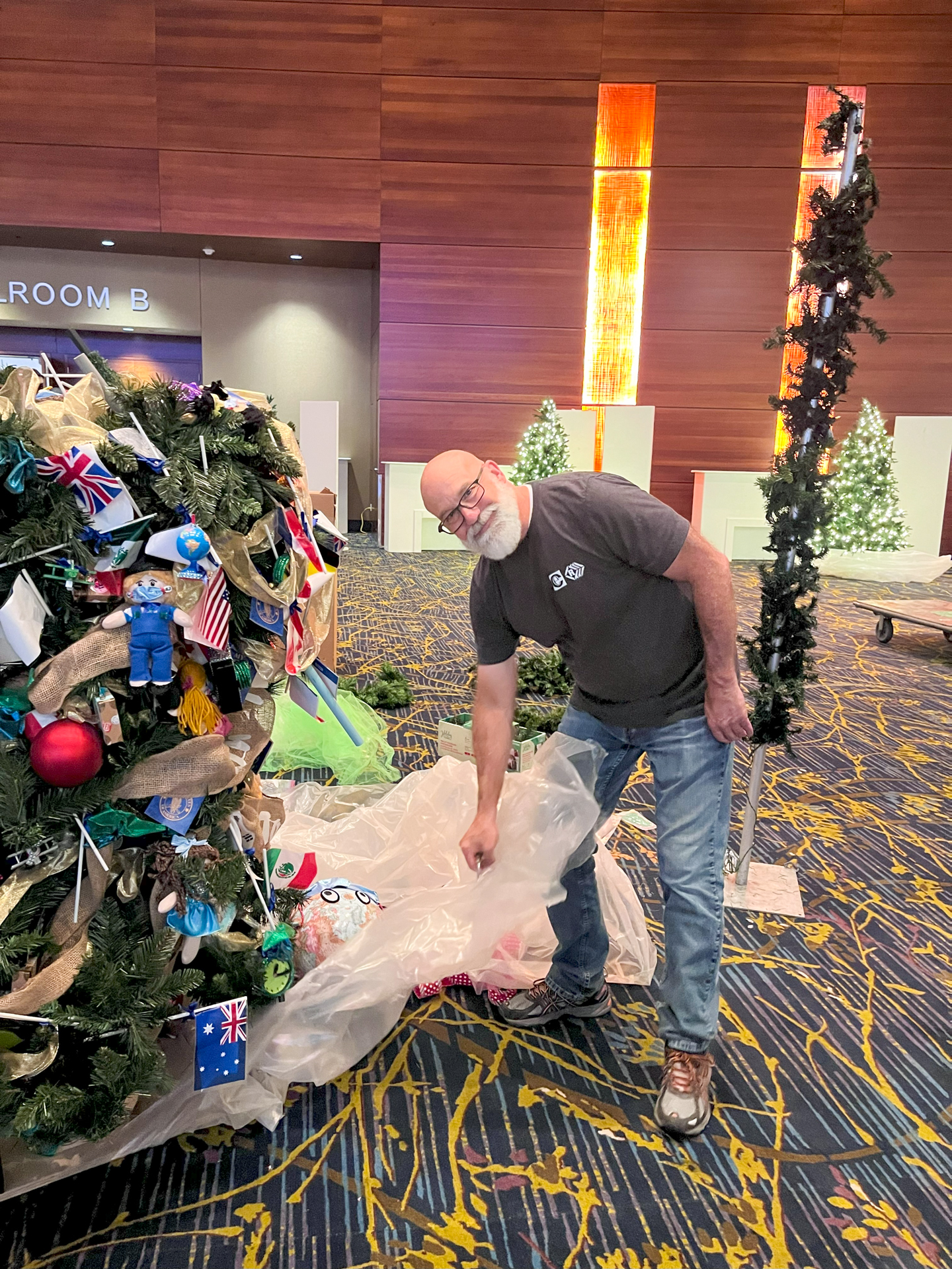 Service Manager Jeff Hutchison unbags a Christmas tree.