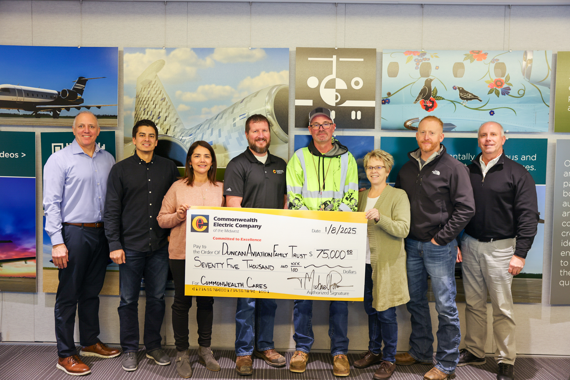 The Lincoln team presents a check to the Duncan Aviation Family Trust.