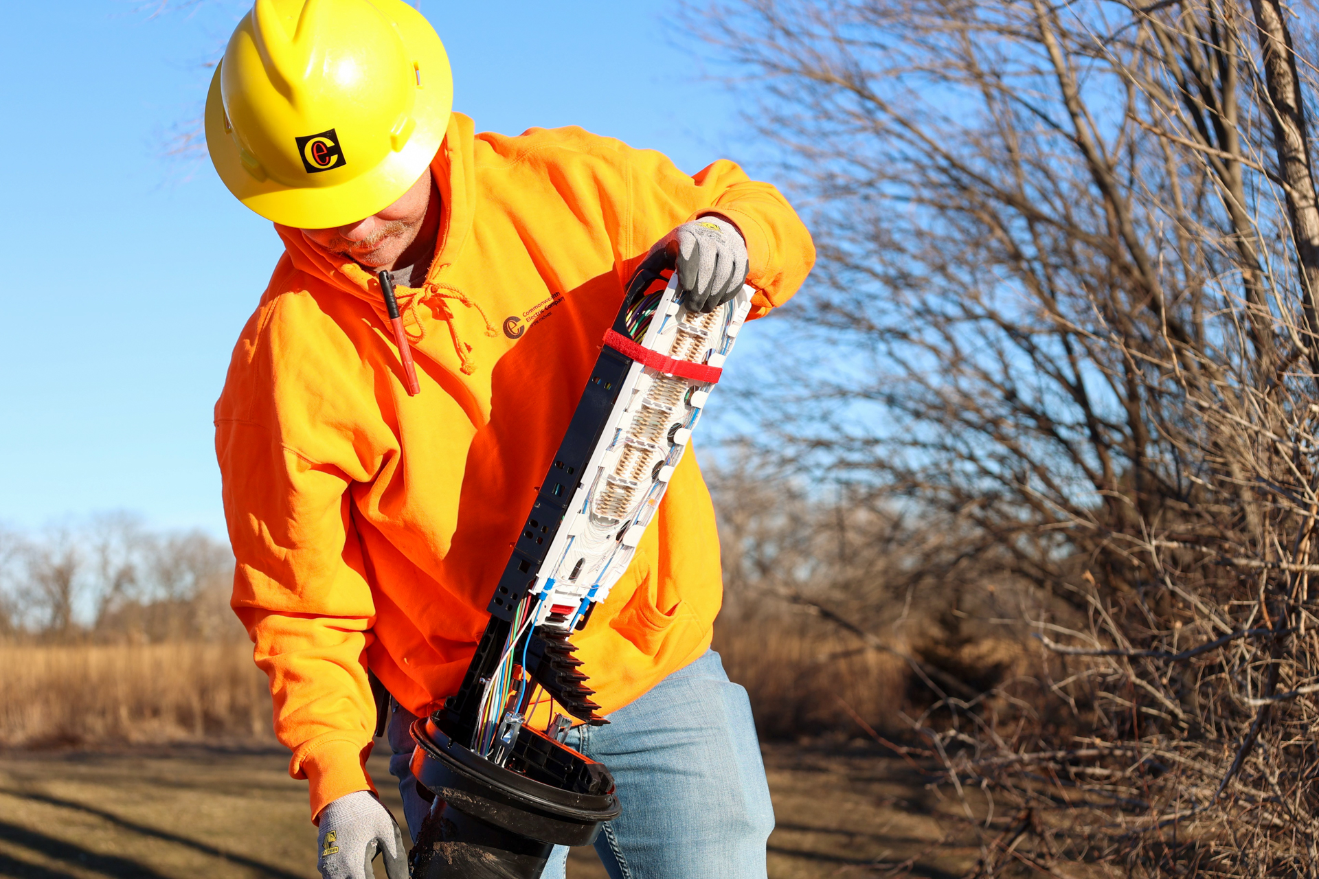 An image of a Commonwealth employee installing a splice closure for SCC's fiber ring.