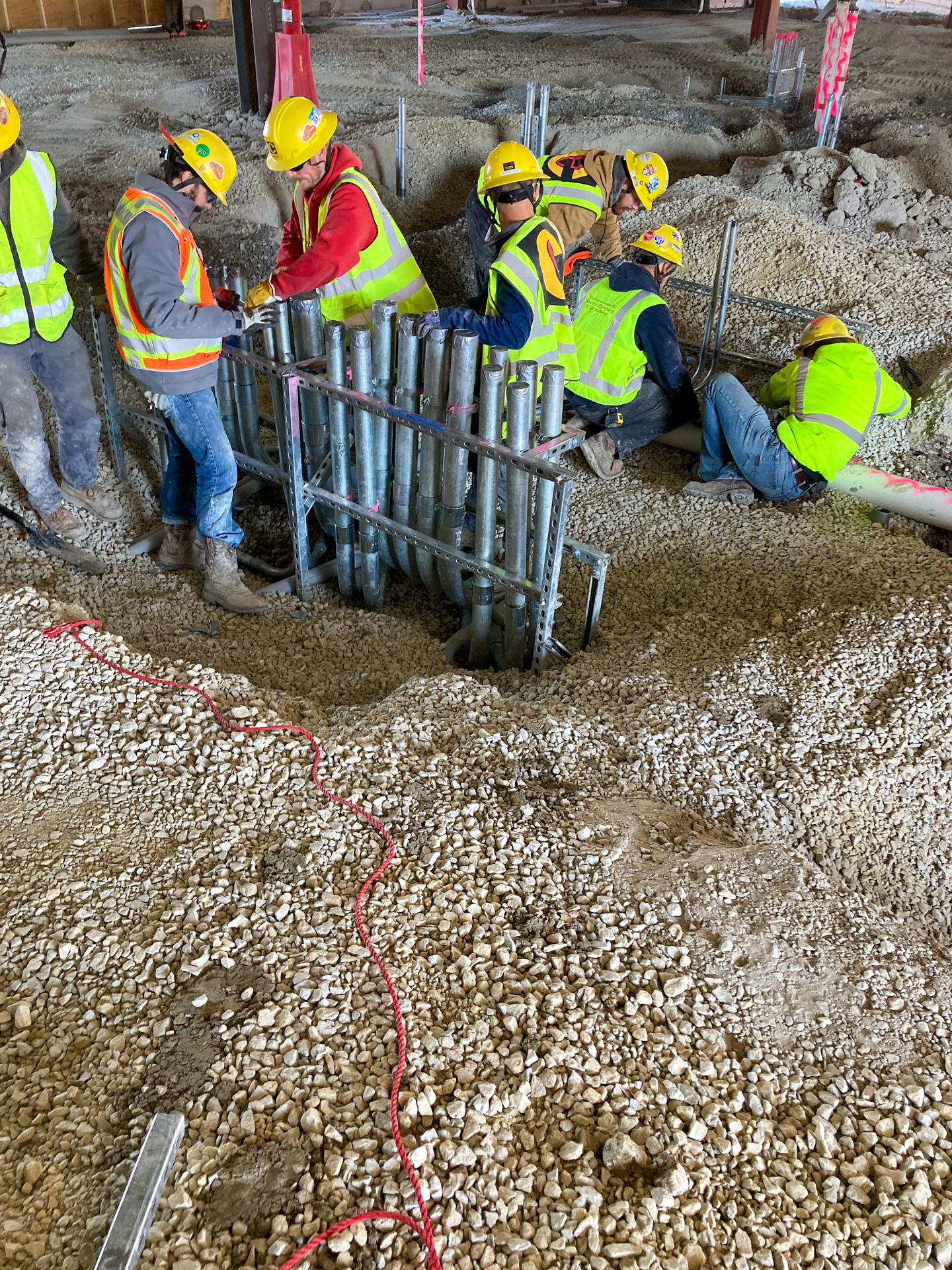 A picture of Commonwealth workers installing underground conduit pipes.