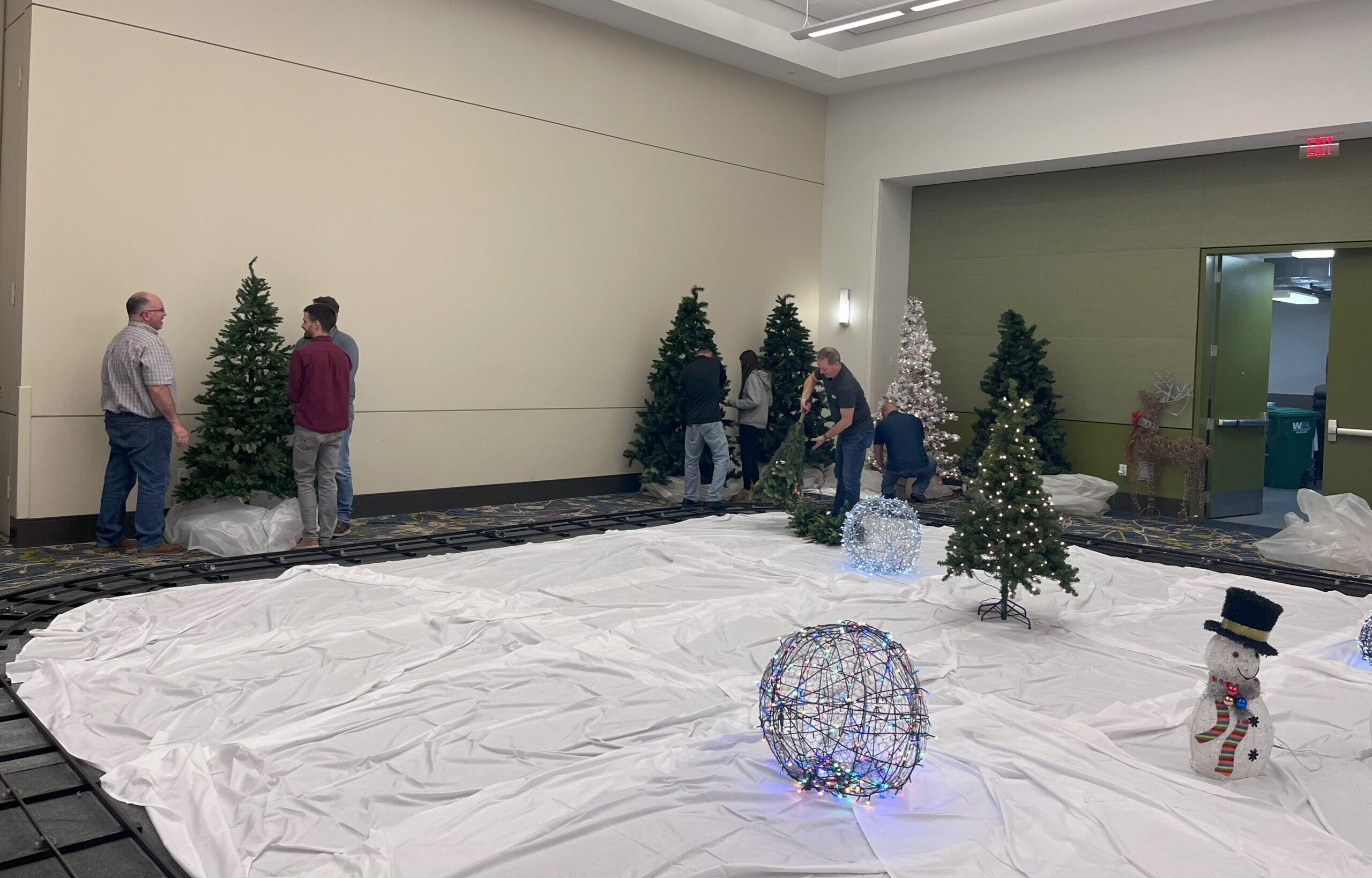 Commonwealth employees set up the track and decor around the Festival Train.